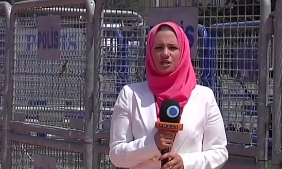 Serena reporting in front of police barriers at Taksim Square, Istanbul.